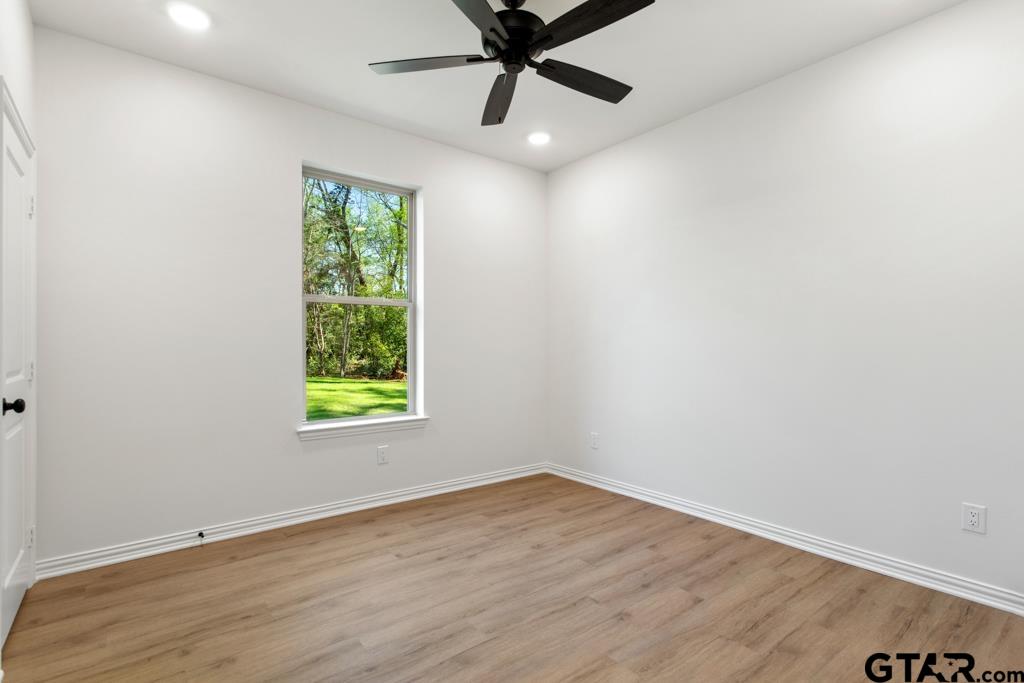 496 Preston Rdg Drive Tyler, TX 75703 - Photo 18 of 34 an empty room with a window and a fan