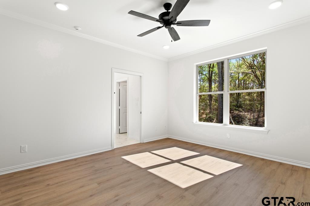 496 Preston Rdg Drive Tyler, TX 75703 - Photo 21 of 34 a view of an empty room with a window and wooden floor