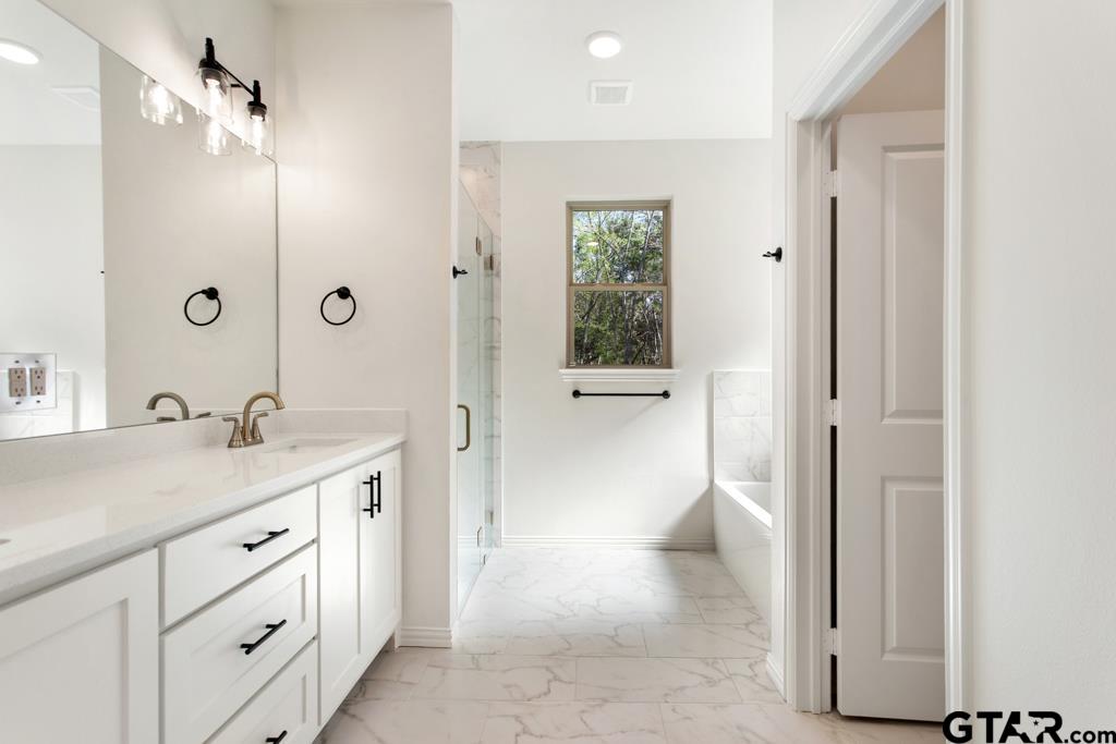 496 Preston Rdg Drive Tyler, TX 75703 - Photo 23 of 34 a spacious bathroom with a shower sink and toilet