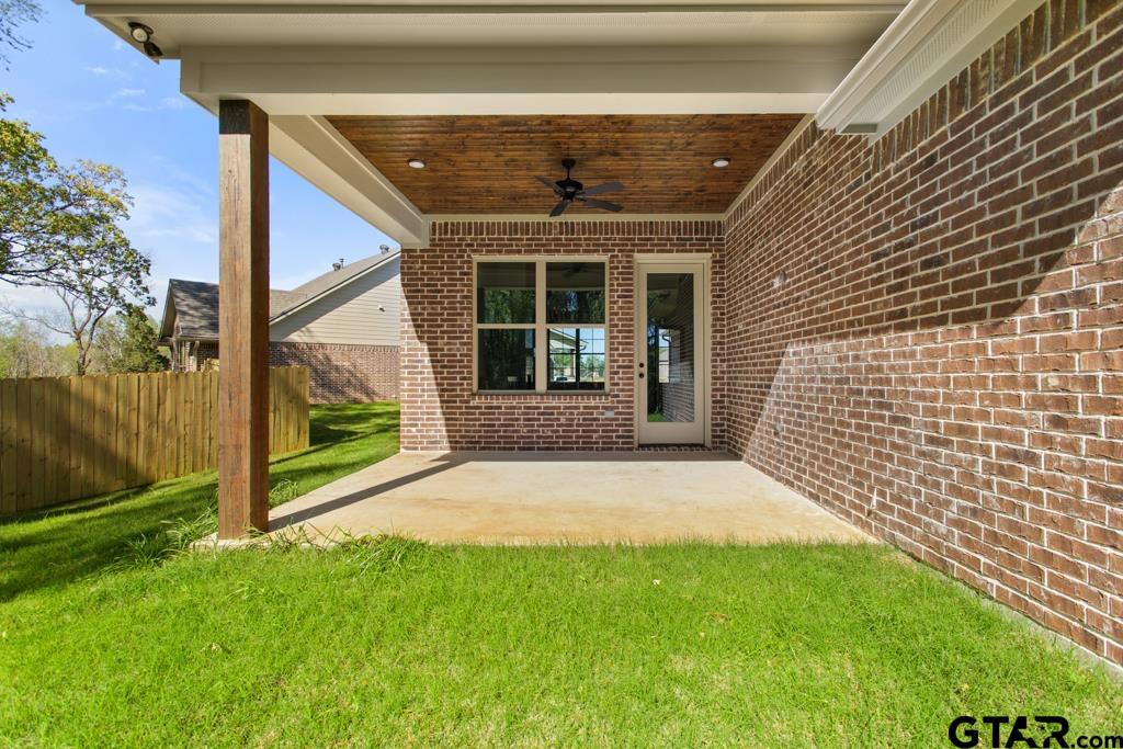 496 Preston Rdg Drive Tyler, TX 75703 - Photo 26 of 34 a front view of a house with a garden