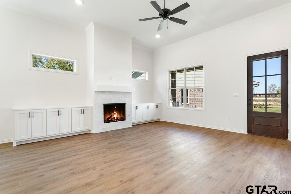 496 Preston Rdg Drive Tyler, TX 75703 - Photo 6 of 34 a view of a room with wooden floor fireplace and windows