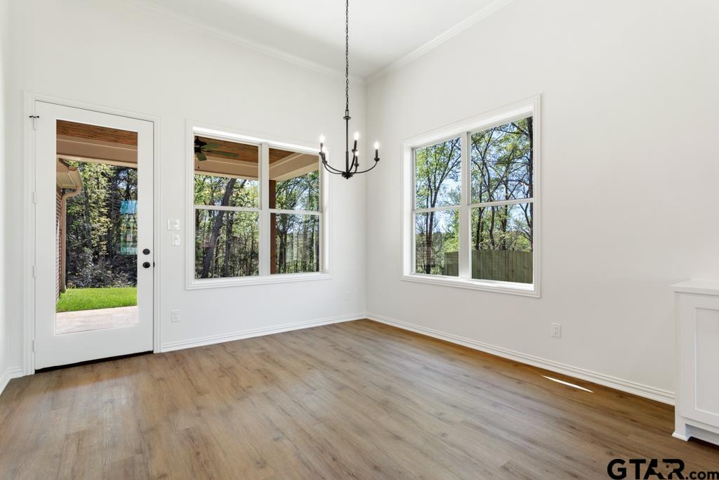 496 Preston Rdg Drive Tyler, TX 75703 - Photo 7 of 34 a view of an empty room with wooden floor and windows