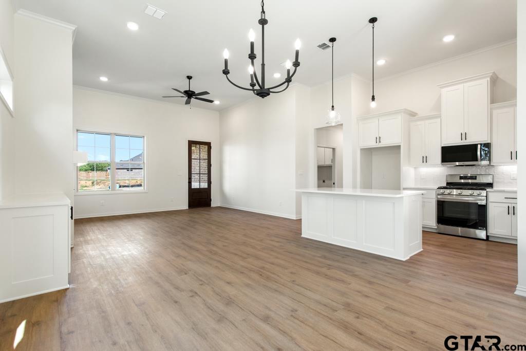 496 Preston Rdg Drive Tyler, TX 75703 - Photo 8 of 34 a kitchen with stainless steel appliances kitchen island a refrigerator and a fireplace