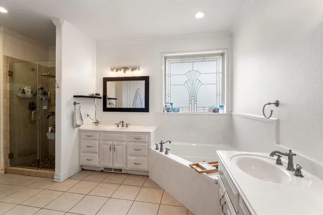 a bathroom with a tub sink and mirror