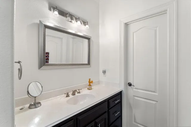 a bathroom with a sink vanity and a mirror