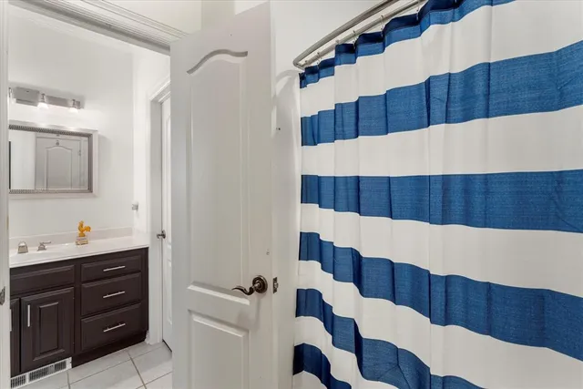 a view of a walk in closet and wooden cabinets