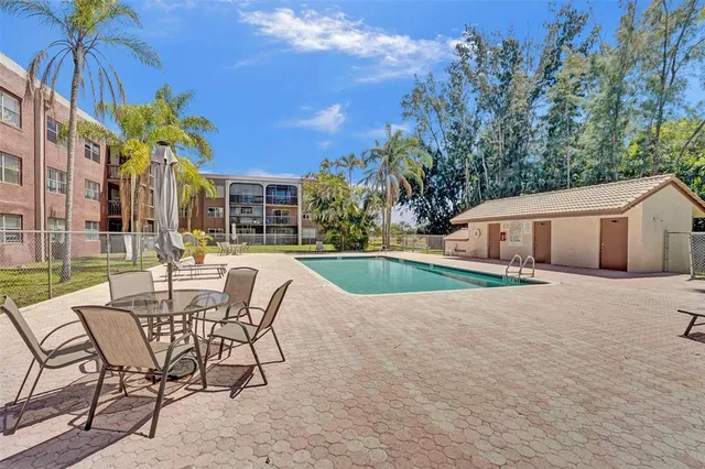 a view of a house with swimming pool and sitting area