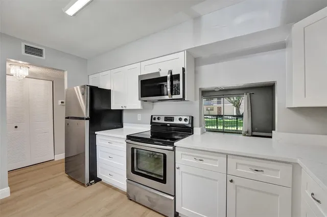 a kitchen with a stove microwave and refrigerator