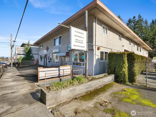 a view of a shop with retail shops and traffic signal