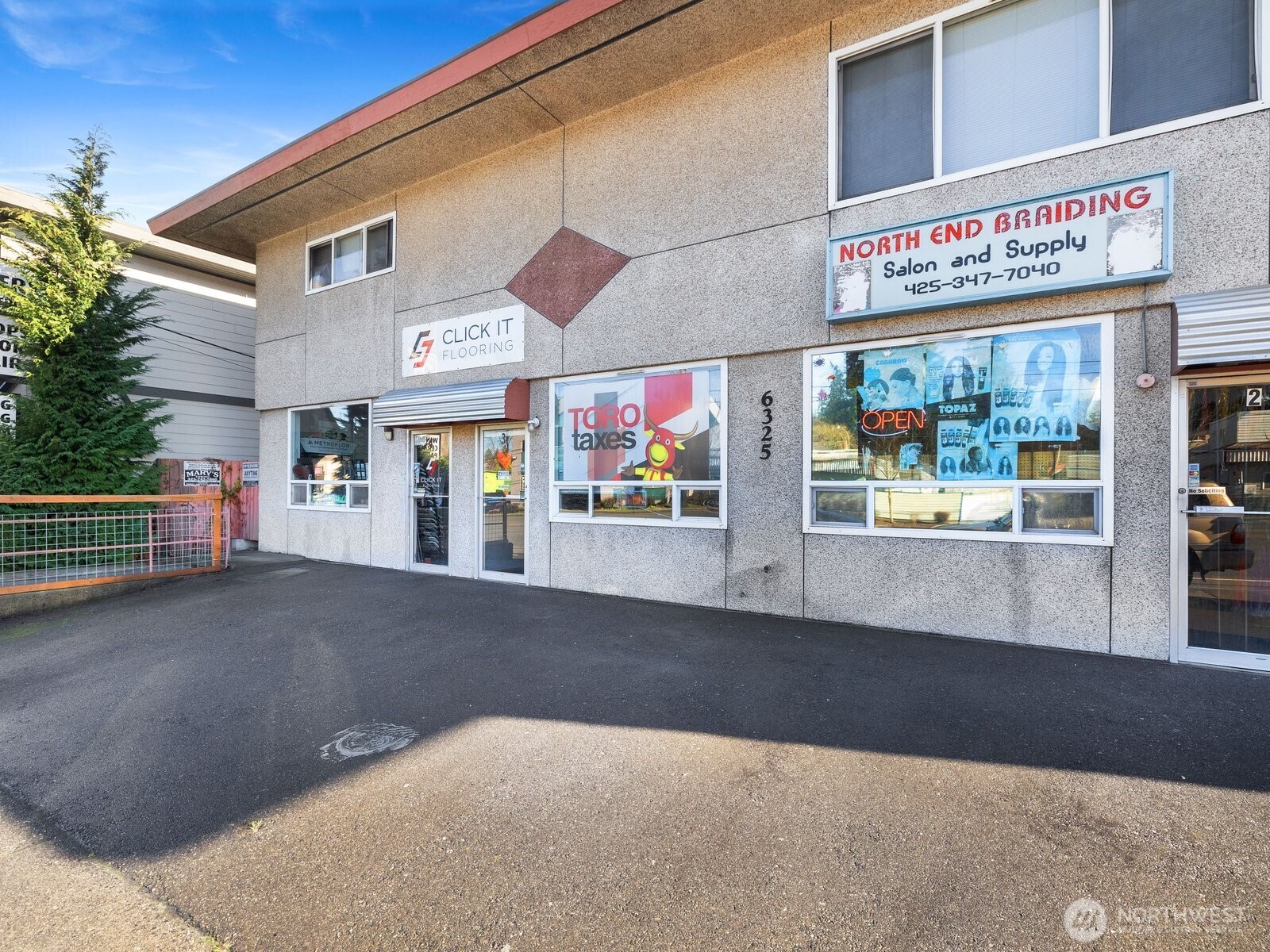 6325 Evergreen Way Everett, WA 98203 - Photo 6 of 38 a view of a shop with retail shops and traffic signal