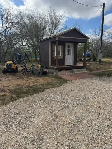 a view of a house with cars parked in front of a house