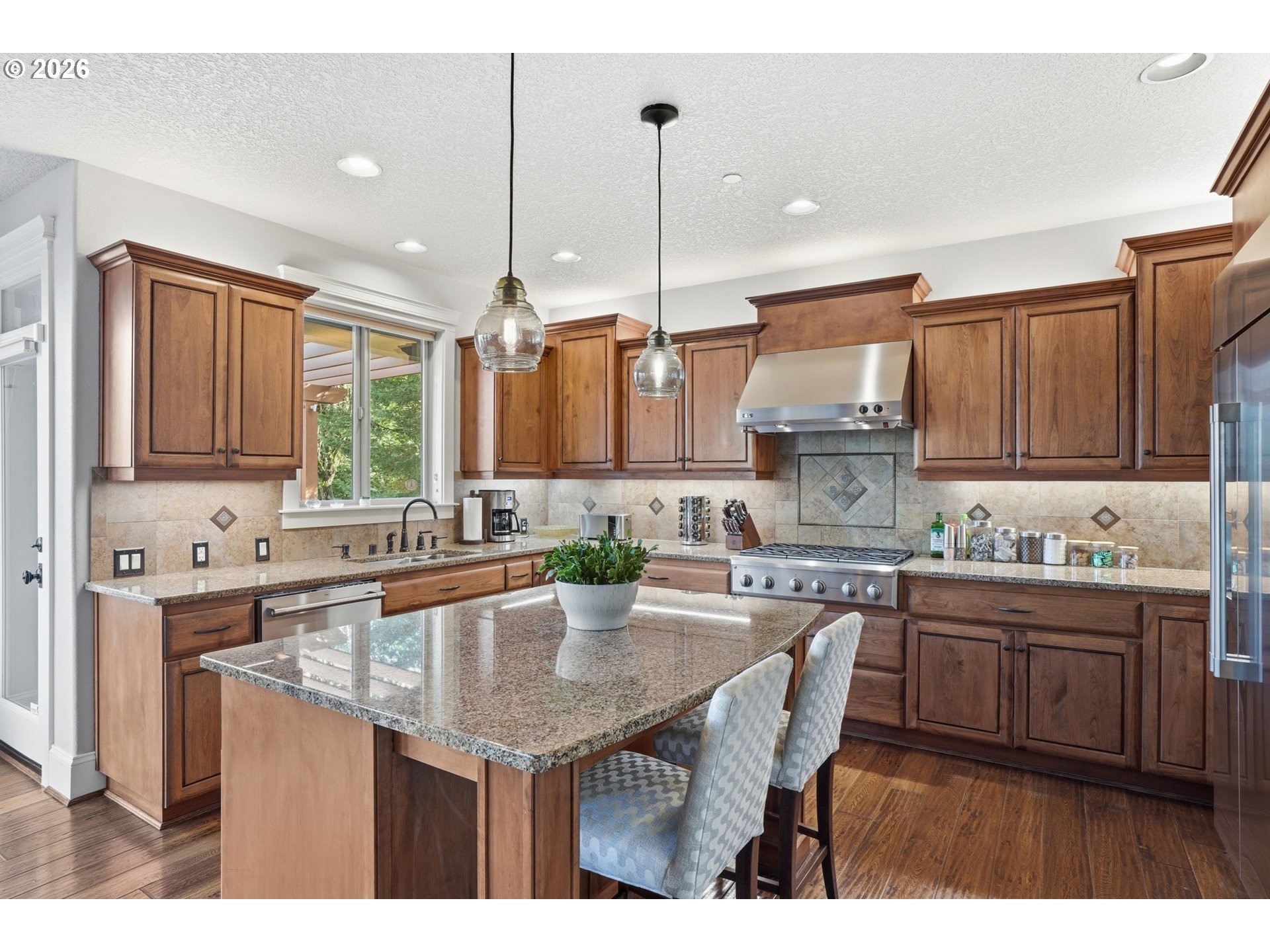 2552 Northwest 12th Circle Camas, WA 98607 - Photo 14 of 46 a kitchen with kitchen island granite countertop a sink a stove and cabinets