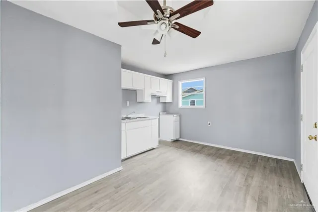 a room with a white cabinets and wooden floor