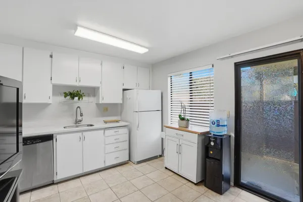 a kitchen with cabinets appliances and a sink