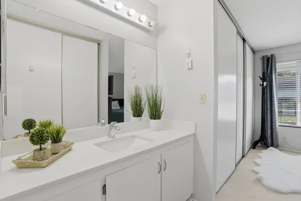a bathroom with a sink a toilet and mirror