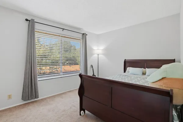 a bedroom with a bed and a window