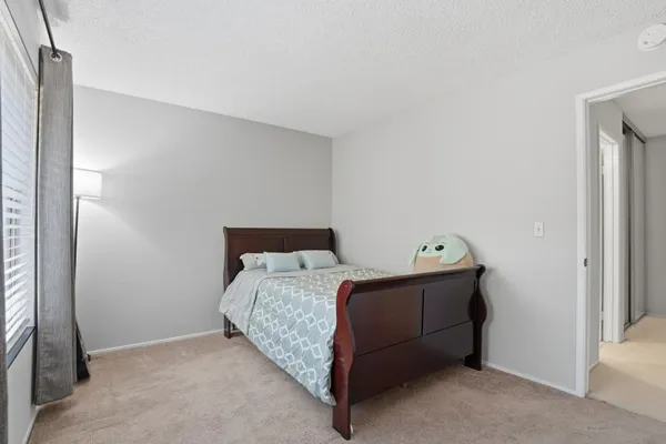 a bedroom with a bed and with potted plant