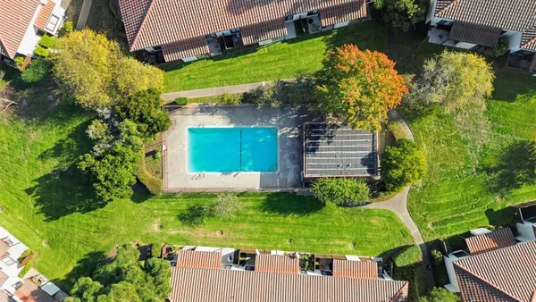 an aerial view of multiple houses with yard
