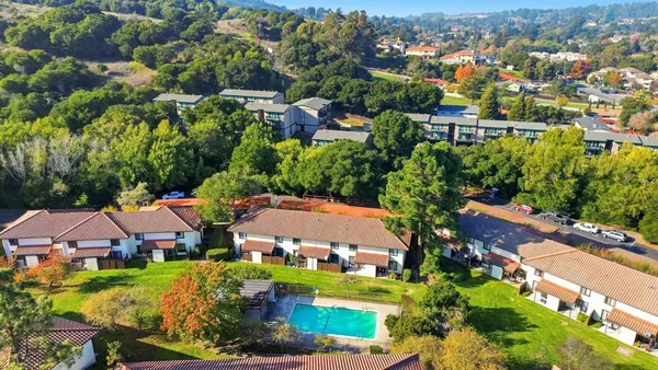 an aerial view of residential houses with outdoor space