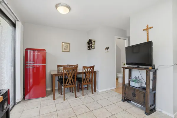 a dining room with furniture and a flat screen tv