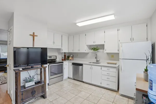 a kitchen with a sink stainless steel appliances and cabinets