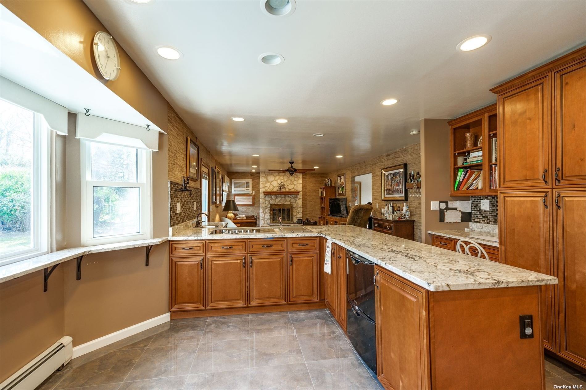 a large kitchen with stainless steel appliances granite countertop a large counter top and a stove