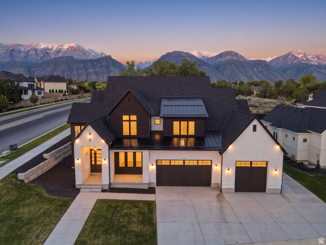Modern architectural exterior featuring white stucco and dark wood-look siding