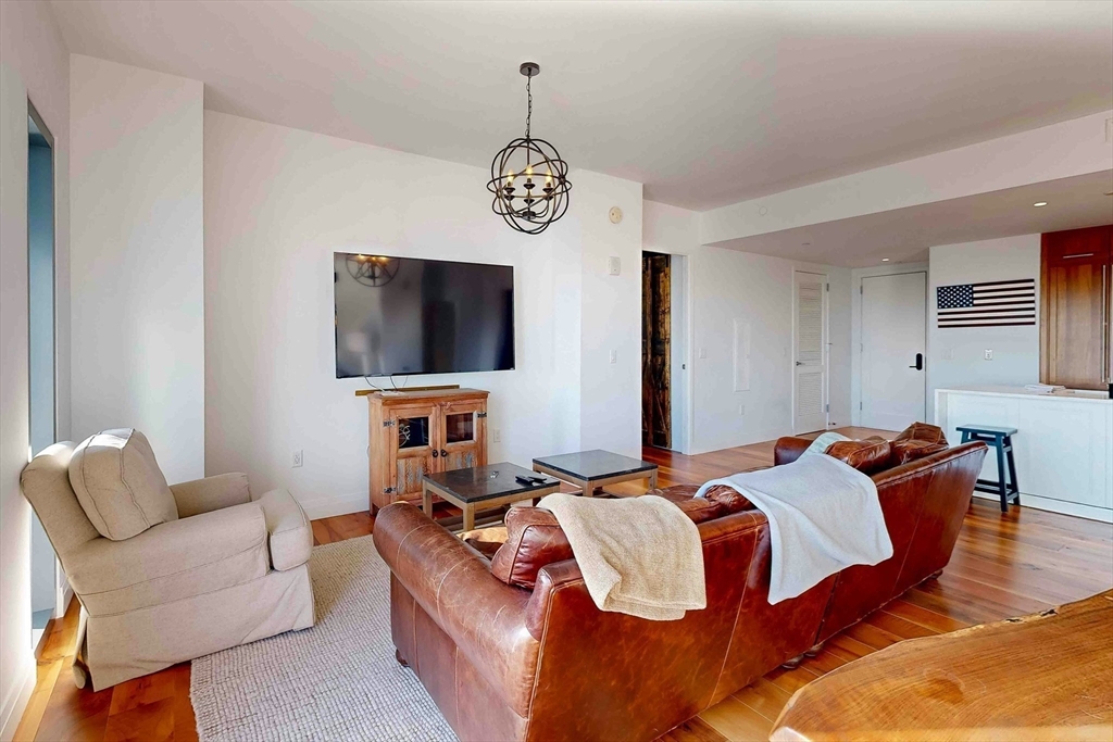 300 Pier 4 Blvd., Unit 6E Boston, MA 02210 - Photo 12 of 36 a bedroom with furniture and a flat screen tv