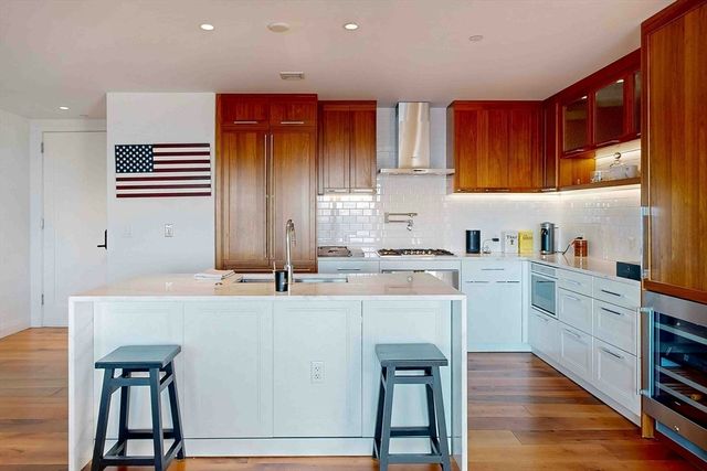 a kitchen with cabinets a sink and appliances