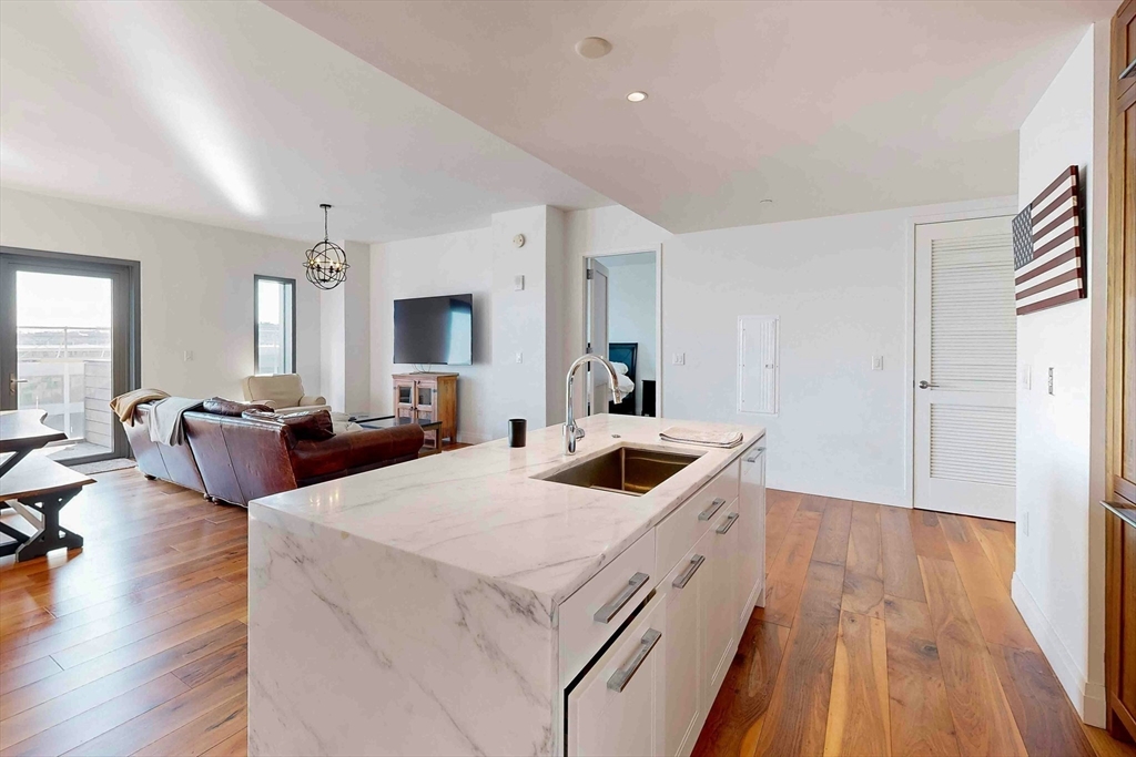 300 Pier 4 Blvd., Unit 6E Boston, MA 02210 - Photo 19 of 36 a living room with furniture and a wooden floor