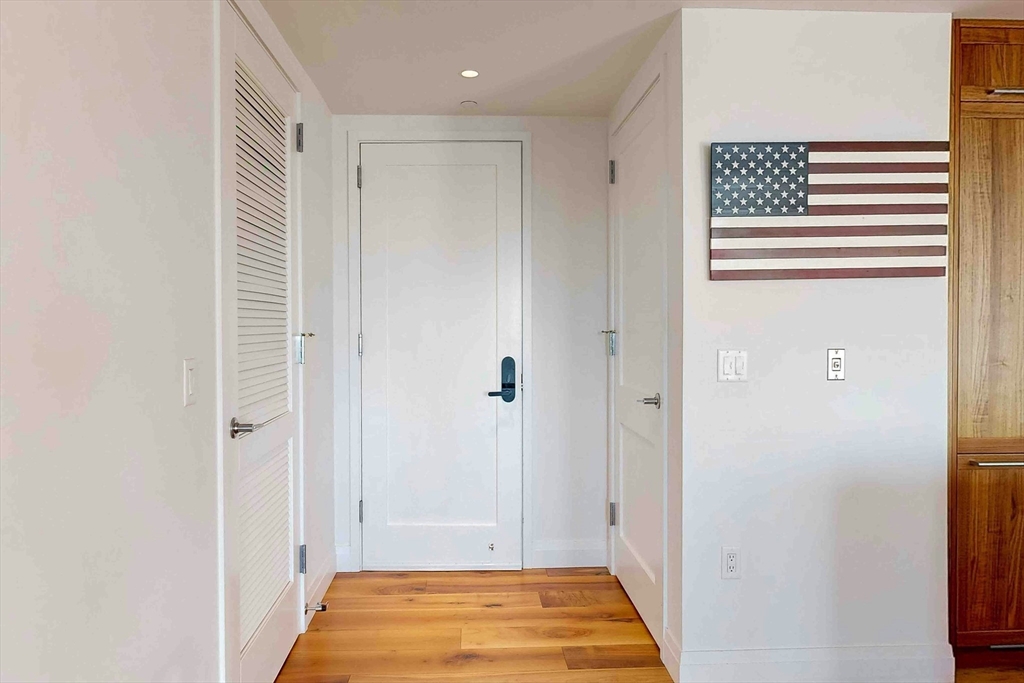 300 Pier 4 Blvd., Unit 6E Boston, MA 02210 - Photo 21 of 36 a view of hallway with walk in closet and wooden floor