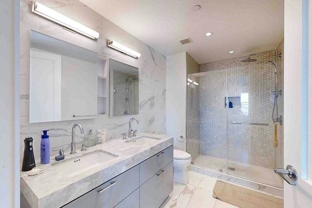 a en suite bathroom with a sink and a mirror