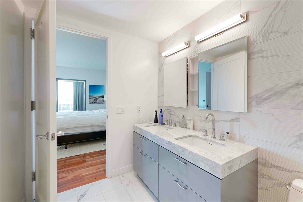 300 Pier 4 Blvd., Unit 6E Boston, MA 02210 - Photo 26 of 36 a en suite bathroom with a sink and a mirror