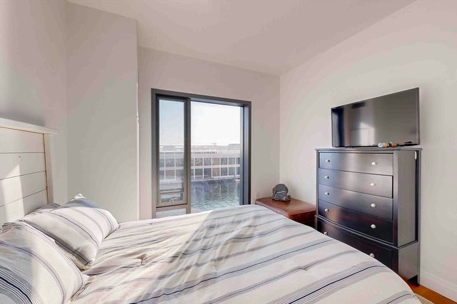 a bedroom with a bed and a mirror