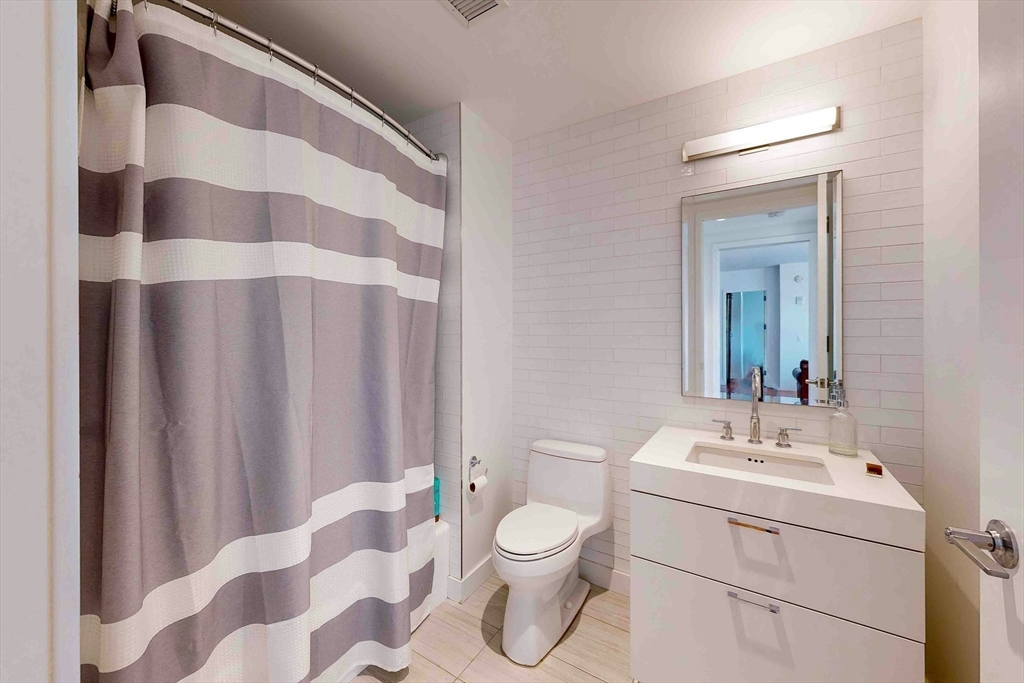300 Pier 4 Blvd., Unit 6E Boston, MA 02210 - Photo 32 of 36 a bathroom with a sink toilet and shower