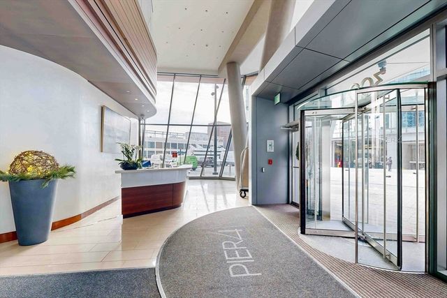 a living room with furniture windows and wooden floor