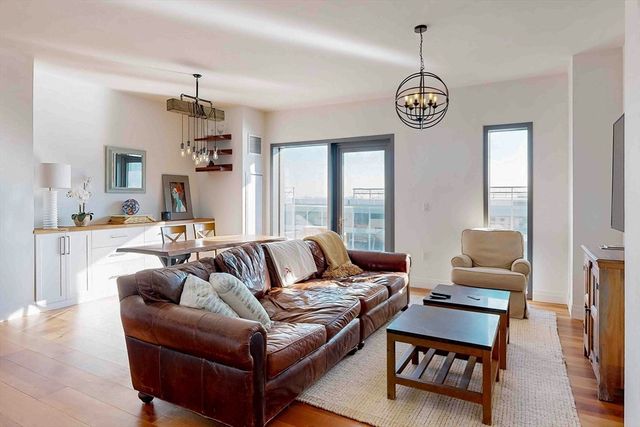 a living room with furniture and kitchen view