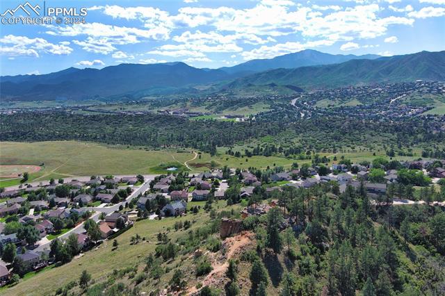 1490 Bison Ridge Drive Colorado Springs, CO 80919 - Photo 6 of 8 Drone / aerial view with a mountain view