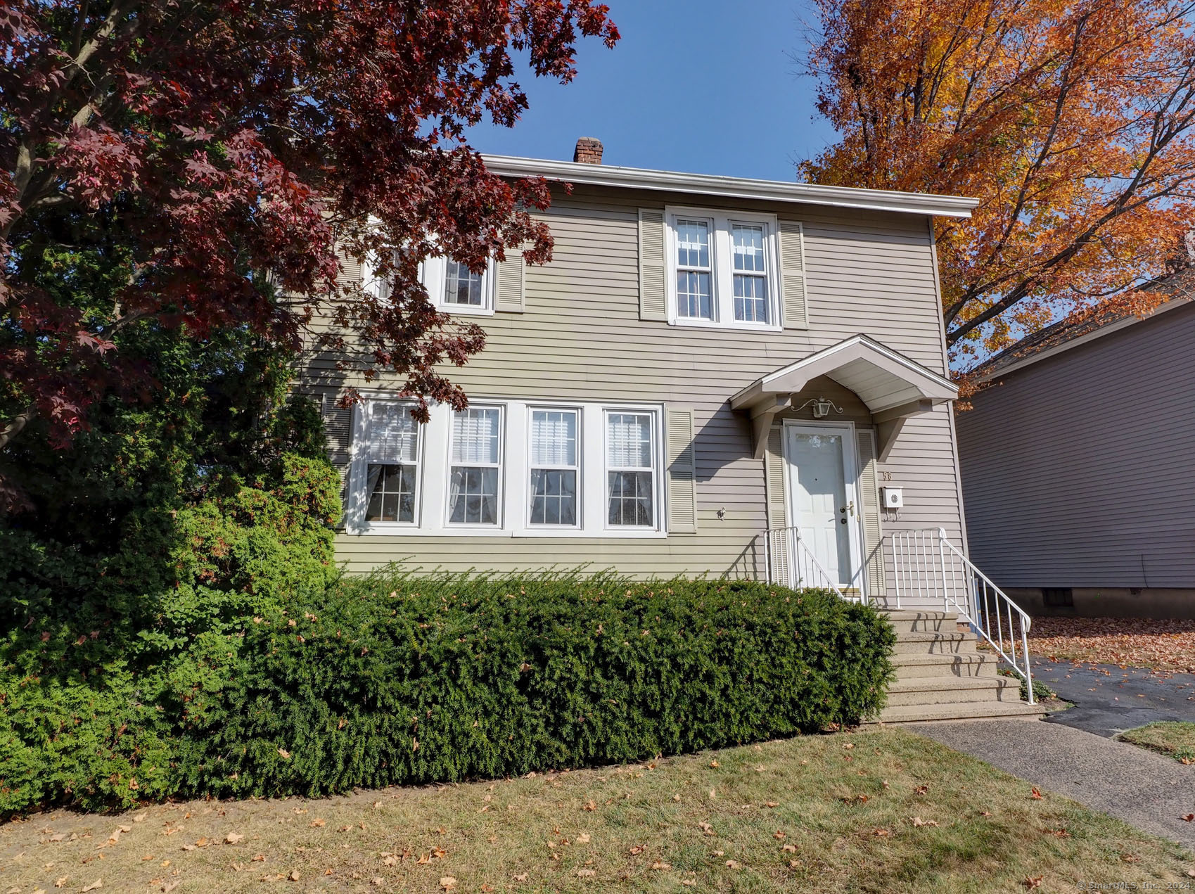 a front view of a house with a yard