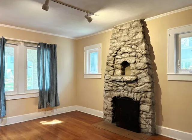 wooden floor in an empty room with a window