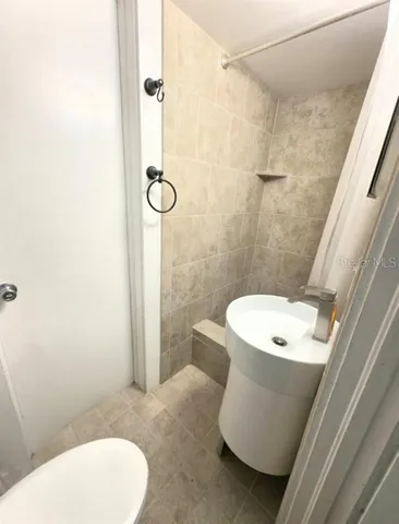 a white toilet sitting next to a bathroom sink