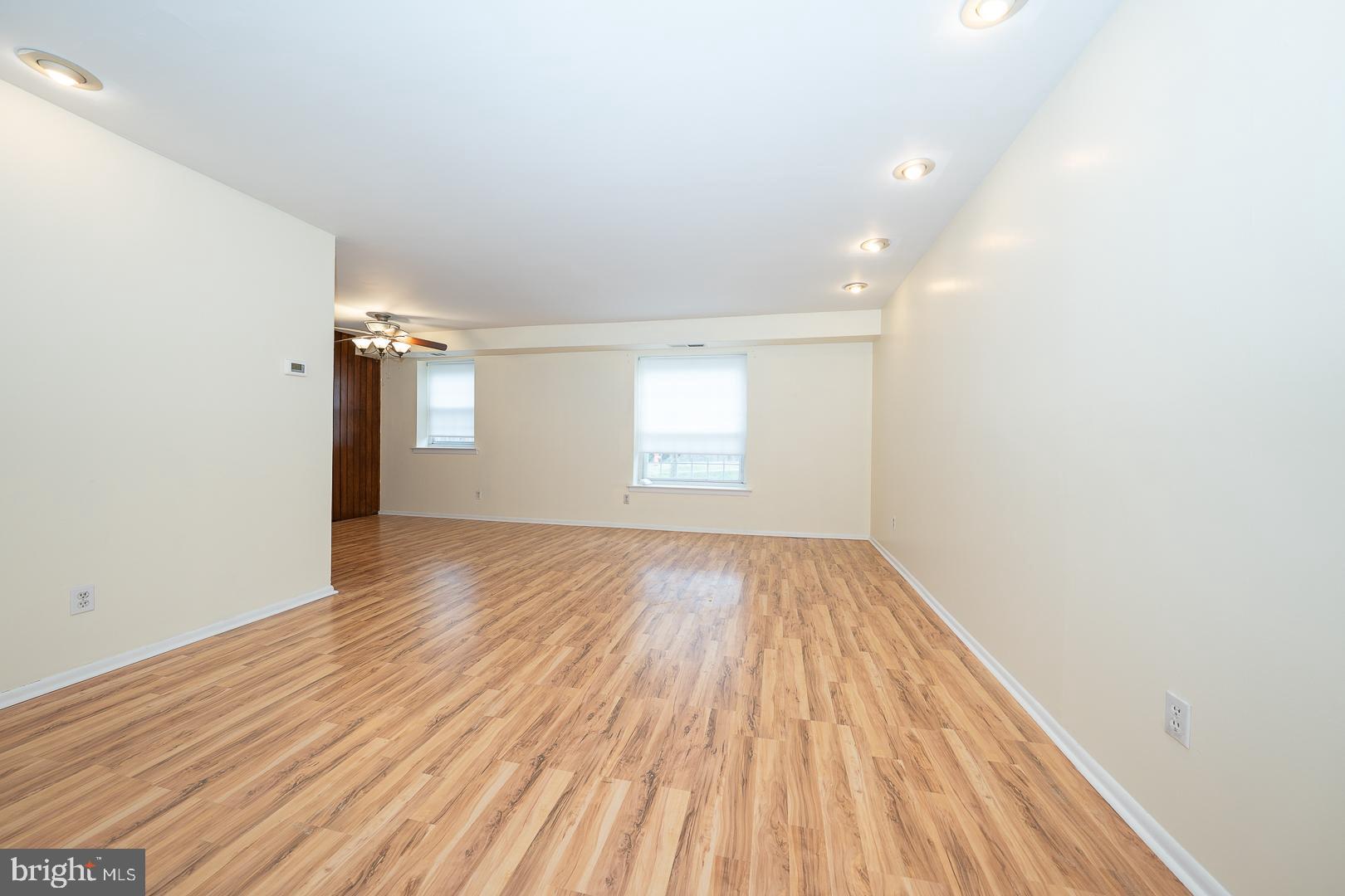 4000 Gypsy Lane, Unit 316A Philadelphia, PA 19129 - Photo 4 of 30 an empty room with wooden floor and windows