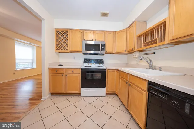 a kitchen with stainless steel appliances a stove sink and microwave