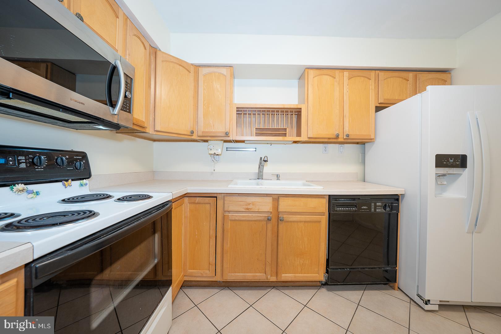 4000 Gypsy Lane, Unit 316A Philadelphia, PA 19129 - Photo 9 of 30 a kitchen with stainless steel appliances granite countertop a sink stove and refrigerator