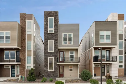 a front view of a residential apartment building with a yard