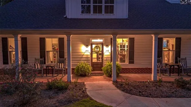 a view of a house with backyard porch and sitting area
