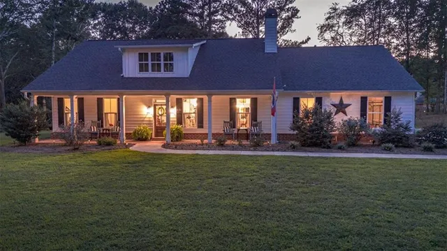 a front view of house with yard and outdoor seating