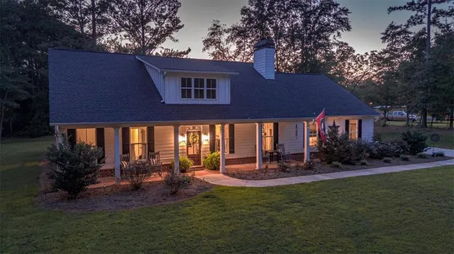 a view of a porch with potted plants and floor to ceiling window