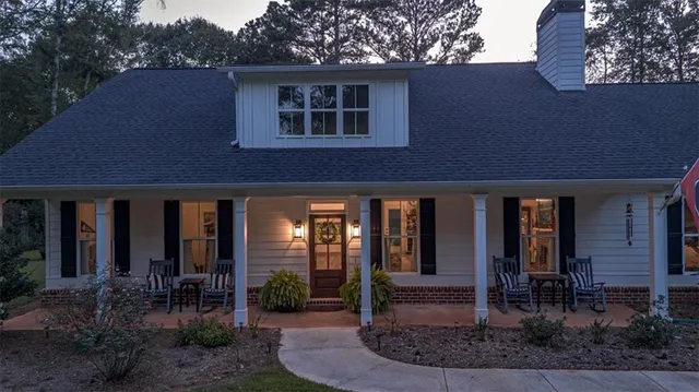 a front view of a house with a garden