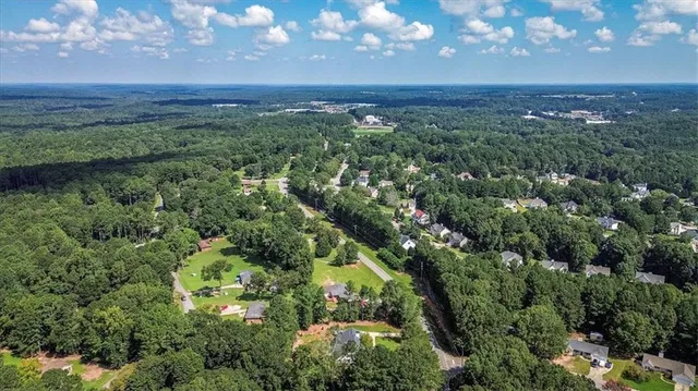 an aerial view of a house with a yard and lake view